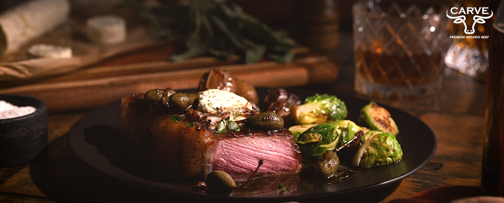 Carve Beef Seared Striploin with Whiskey-Sage Compound Butter and Caper Berries Recipe Photo