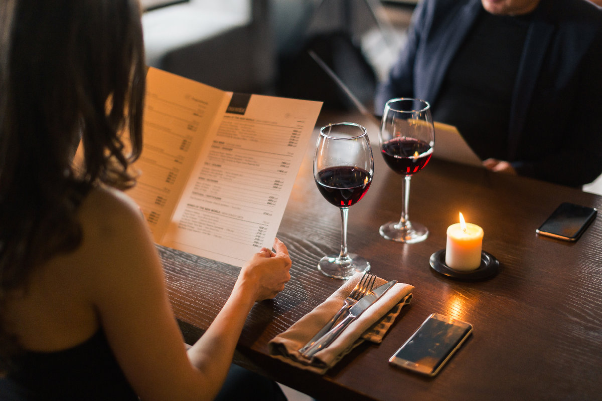 Woman in restaurant holding menu