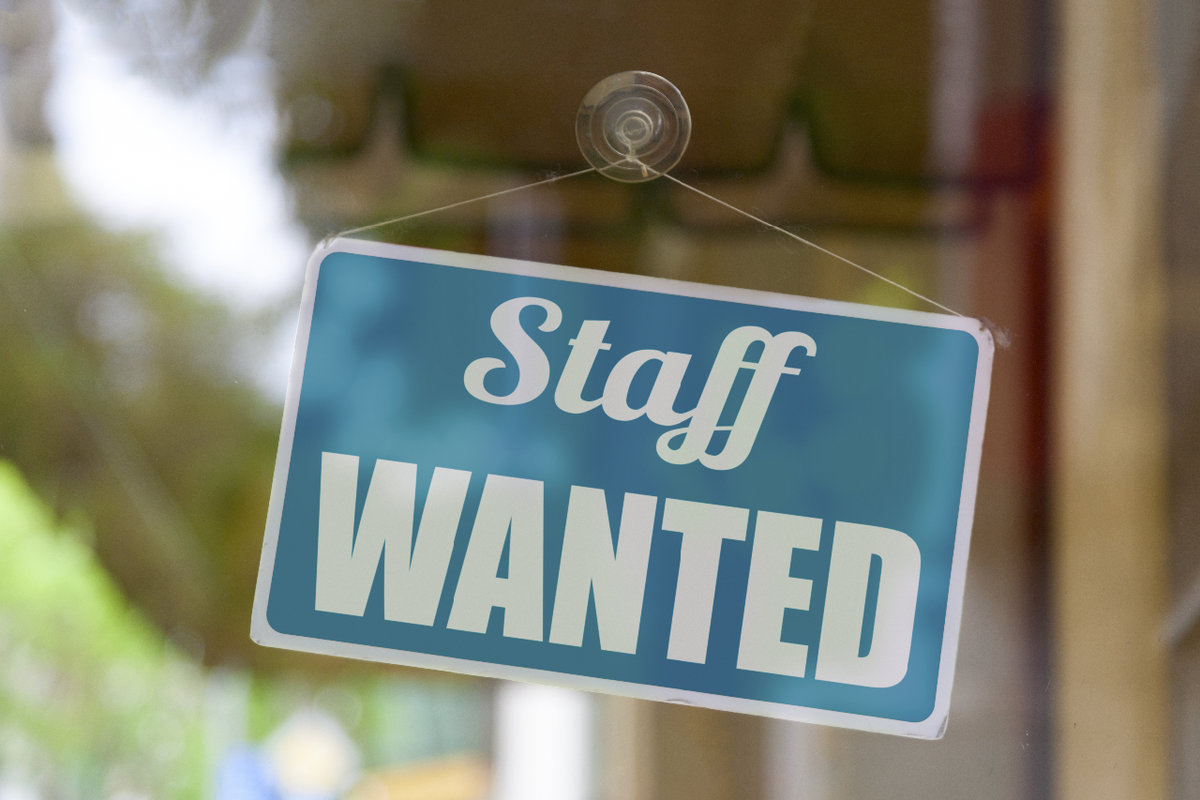 Staff wanted sign hanging in window