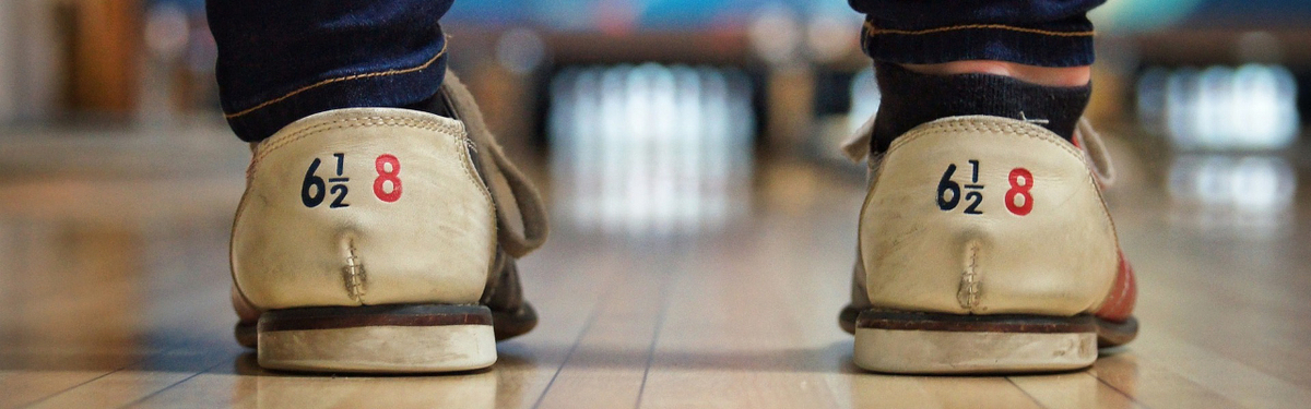 A person wearing bowling shoes