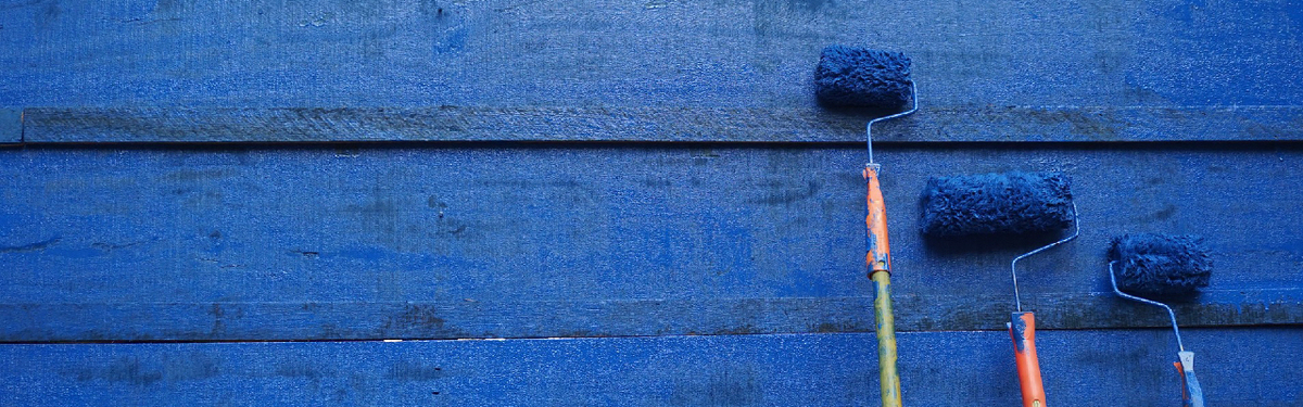 Blue wall with blue paint rollers