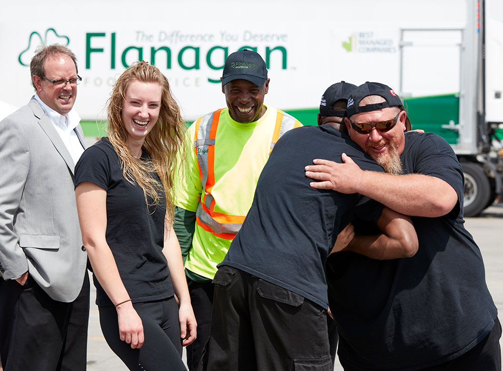 Flanagan Foodservice drivers laughing and hugging Flanagan AZ Drivers Team Photo