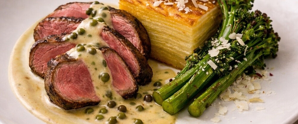 Herb-Butter Tenderloin with Truffle Hollandaise on a plate