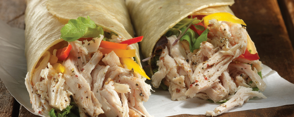 Schneiders pulled chicken piri piri wraps on a wood background